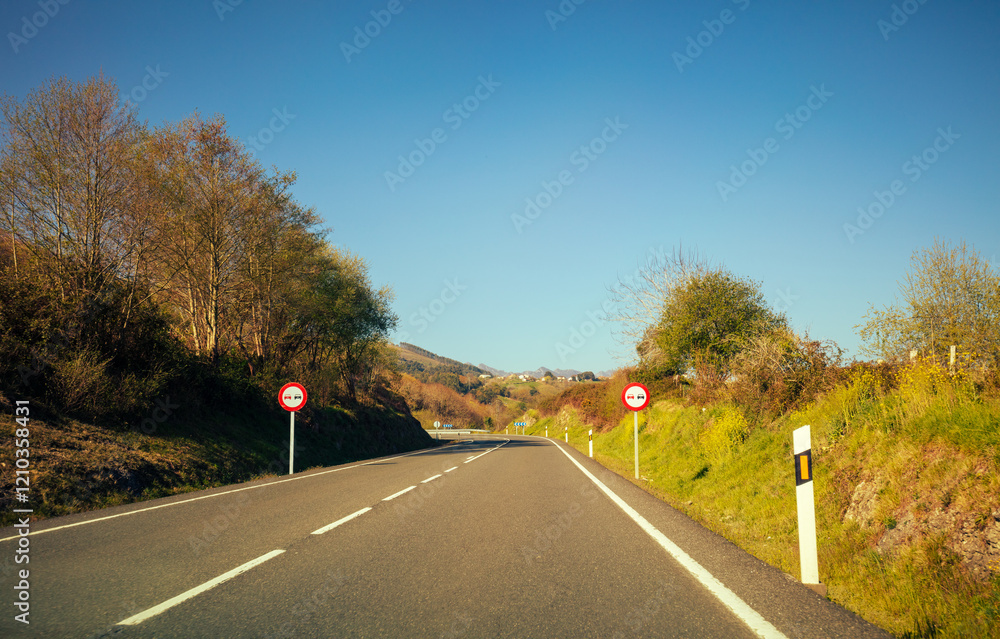 View of a beautiful mountain landscape through the windshield on a sunny day. Driving a car on a mountain road in the Picos de Europa National Park. Cantabria, Spain, Europe