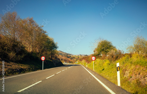 Obraz na płótnie View of a beautiful mountain landscape through the windshield on a sunny day. Driving a car on a mountain road in the Picos de Europa National Park. Cantabria, Spain, Europe w salonie