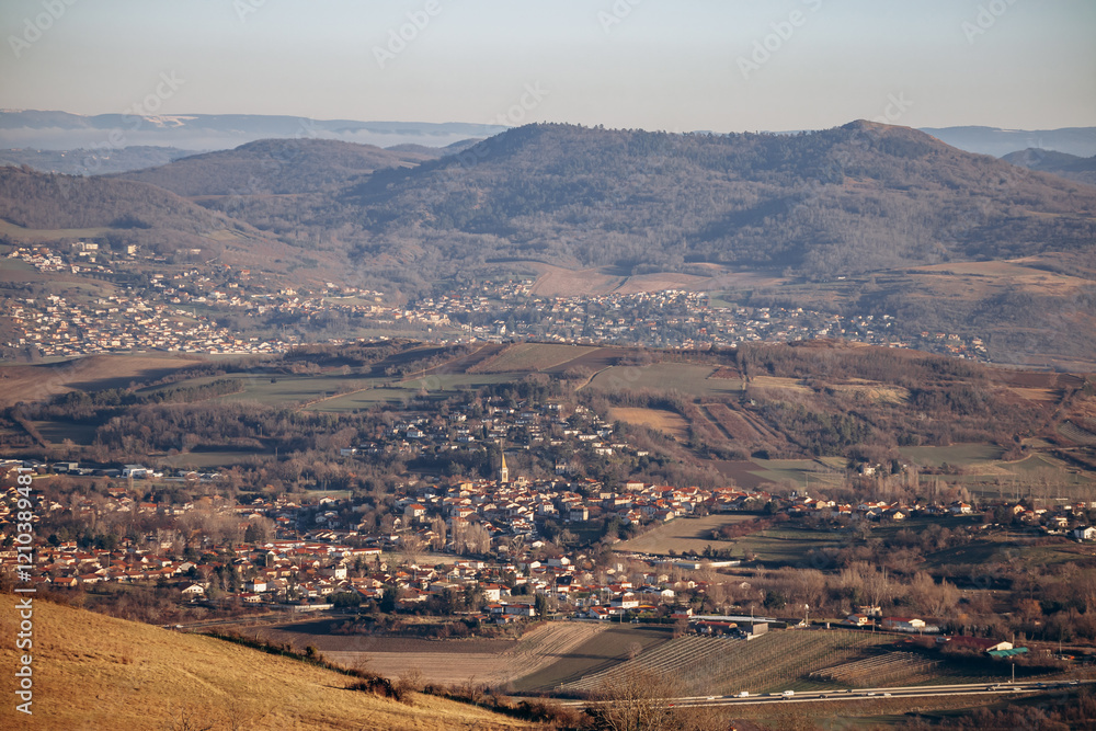 Obraz premium View from Plateau de Gergovie to Clermont-Ferrand suburbs on a winter sunset