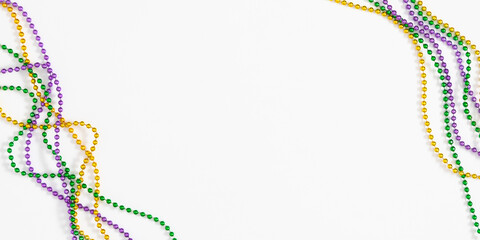 Mardi Gras beads composition background. Festive banner with colorful beads for Mardi Gras celebration on white background. Top view, flat lay.