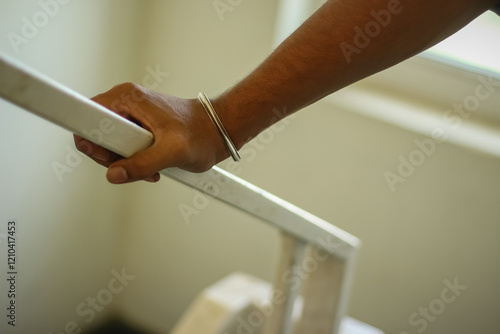 A Man Holds the Iron Steps for Climbing Up. photo