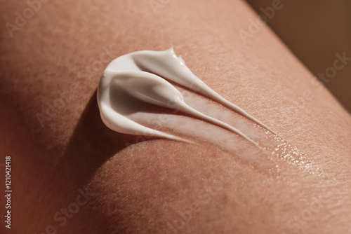 White body cream on dry human skin.