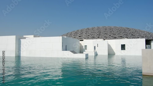 Abu Dhabi, United Arab Emirates - January 6, 2024: Louvre Abu Dhabi, showcasing its stunning modern architecture and iconic dome. museum s unique design and serene waterfront,