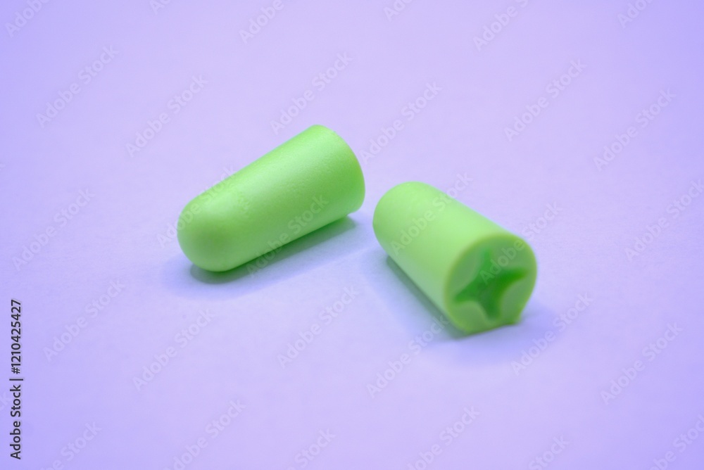 Hearing protection. A pair of green earplugs on a white background. Hearing protection. A pair of green earplugs on a white background.