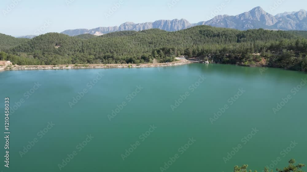 Tranquil lake surrounded by mountains and trees in beautiful nature