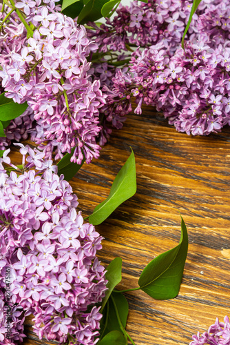 Beautiful spring flowers lilac on a wooden vintage board with place for text. Syringa vulgaris. Happy Mother's Day greetings card.