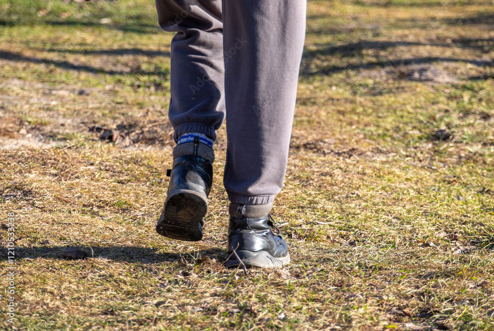 A person is walking in the grass with their feet in the air A person is walking in the grass with their feet in the air