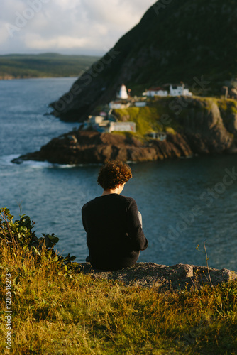 Back view of unrecognizable person at Fort Amherst Lighthouse, Canada photo