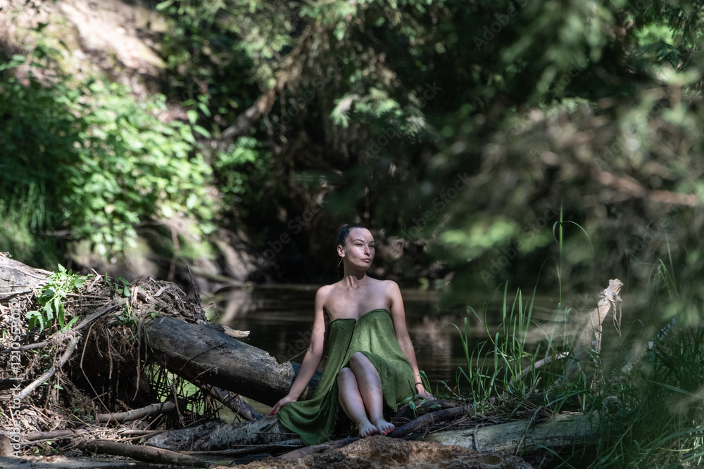 Beautiful young dark-haired girl in a forest river in summer. Beautiful young dark-haired girl in a forest river in summer.