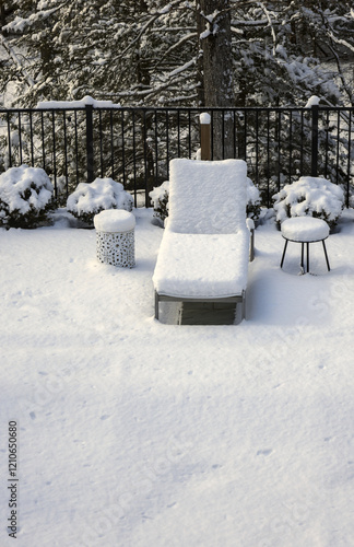 poolside lounge chairs covered in snow during winter (off season spa patio back yard) pool loungers side tables snowy blizzard closed season (recliner reclining chair) end of year photo