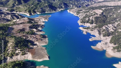 Aerial view revealing glass terrace at ali kayasi overlooking menzelet dam lake, surrounded by mountainous landscape in kahramanmarash region, turkey photo