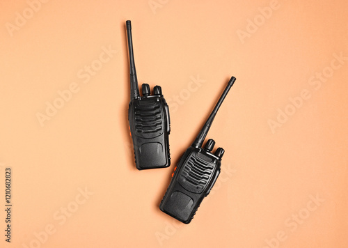 Walkie talkies on beige background, top view photo