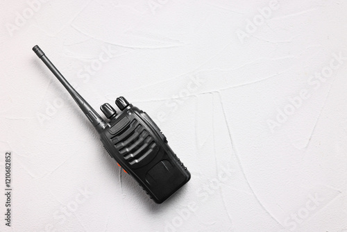 One walkie talkie on white table, top view. Space for text photo