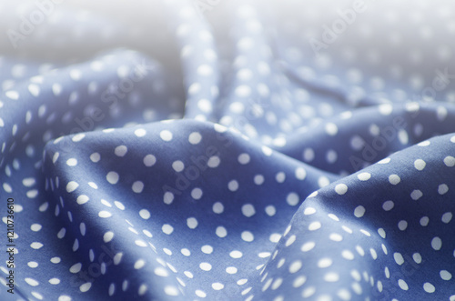 Crumpled dark blue and white cotton fabric with polka dot photo