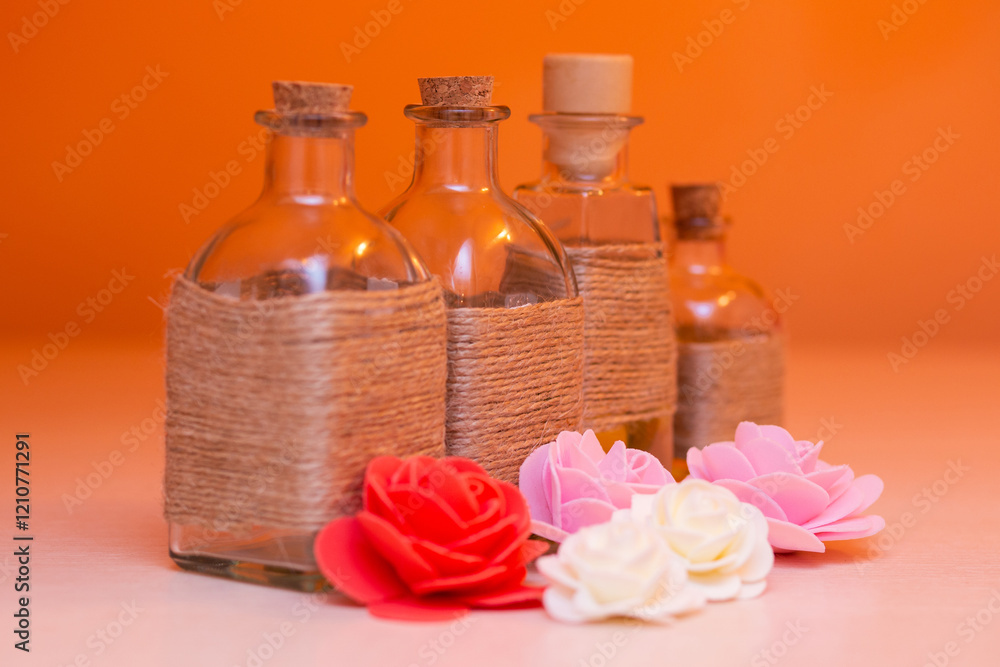 beautiful bottles with massage oil on orange background beautiful bottles with massage oil on orange background