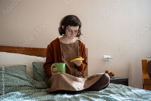 Teenage girl having social difficulties, problems in communication with agemates, spending sunny weekends at home, scrolling photos in social networks, reading news online. Addiction to mobile phone photo