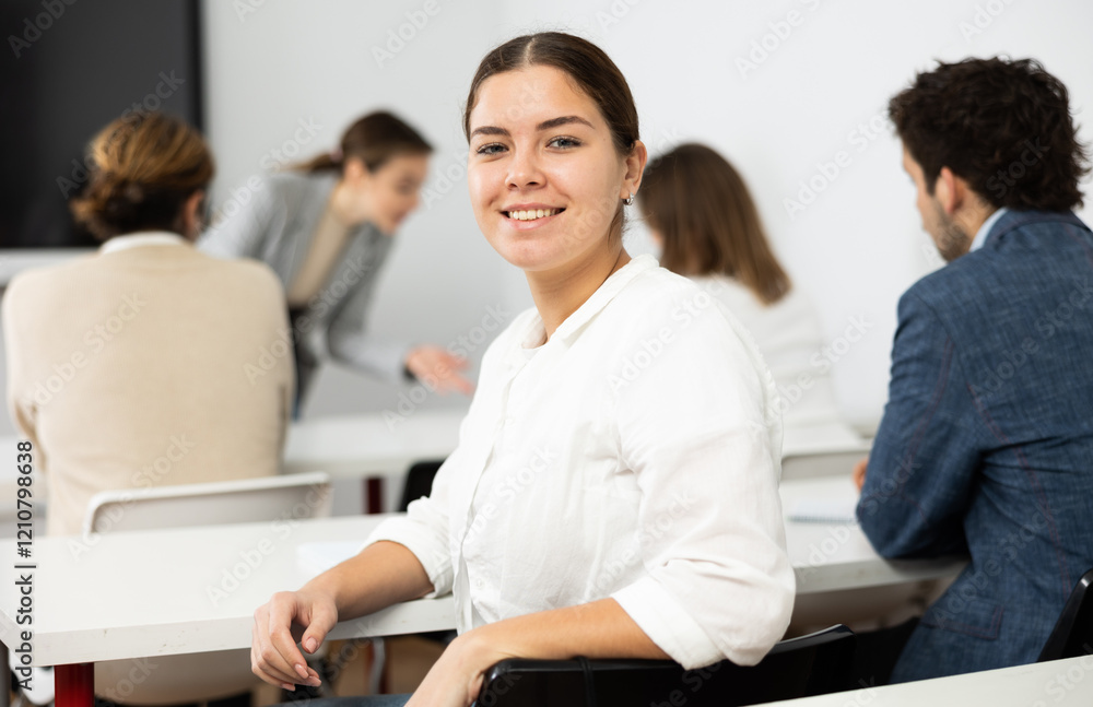 Young smiling woman attending lecture in university Young smiling woman attending lecture in university