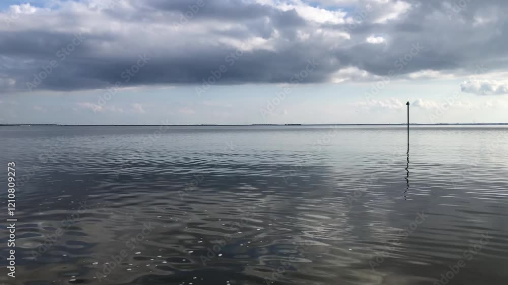 seascape, smooth sea, low dark clouds, view from the side of a boat in motion seascape, smooth sea, low dark clouds, view from the side of a boat in motion