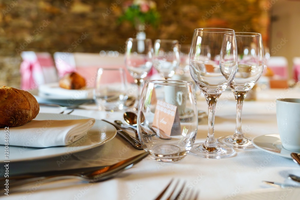 This elegant table setting showcases wine glasses, a freshly baked bread roll, and a beautifully folded napkin, creating the perfect ambiance for a romantic dinner or special celebration. This elegant table setting showcases wine glasses, a freshly baked bread roll, and a beautifully folded napkin, creating the perfect ambiance for a romantic dinner or special celebration.
