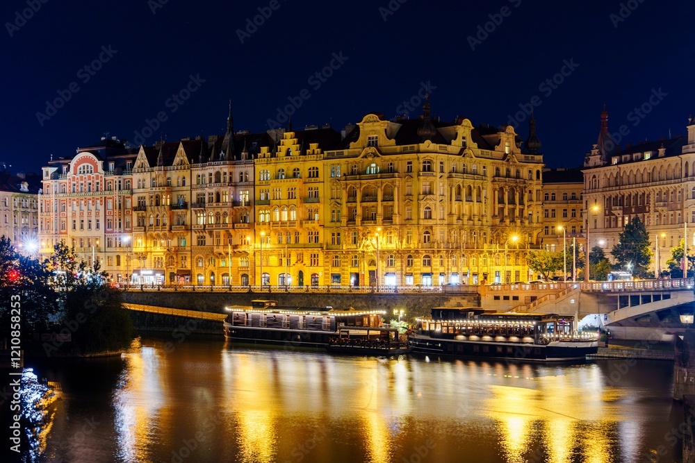 Obraz premium The Vltava River flows through the heart of Prague, Czech Republic, passing by many historic buildings and landmarks, and is a popular tourist destination for those visiting the capital city.