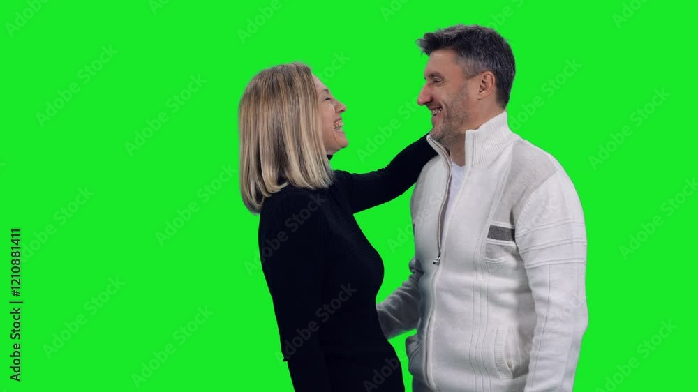 Smiling mid adult loving couple standing on green chroma key background, 4k pre-keyed footage Smiling mid adult loving couple standing on green chroma key background, 4k pre-keyed footage