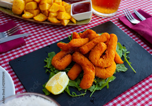 Sepia breaded and fried closeup (chocos, typical tapa in Spain) photo