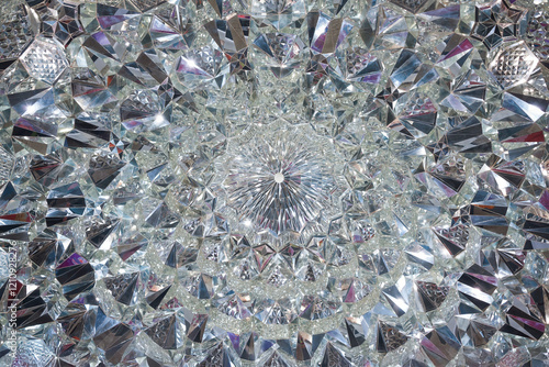 Fotografie Crystal glass symmetrical design refracting light on its cut facets creating a s