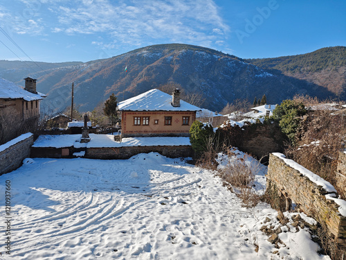 Winter Sunset view of Village of Kovachevitsa with Authentic nineteenth century houses, Blagoevgrad Region, Bulgaria photo