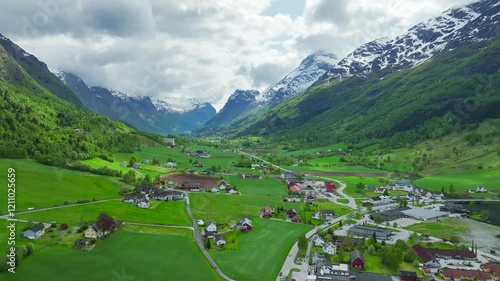 Mountains and Fiord in the clouds over Village from a drone, Olden, Innvikfjorden, Norway