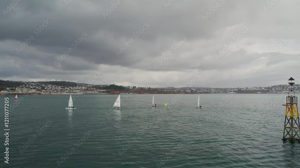 Sailing Club training at cloudy sky from a drone, Paignton, Devon, England Sailing Club training at cloudy sky from a drone, Paignton, Devon, England