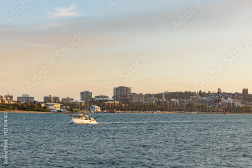 Wallpaper Mural Fishing boat headed out to sea through the Newcastle Breakwater with Newcastle City in background Torontodigital.ca