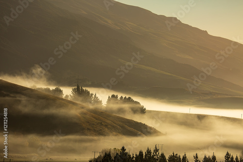 Thick fog in the valley, mist of the hills and frost on the fields. High up in the rural Hills of Berwick (south west of Dunedin) at sunrise