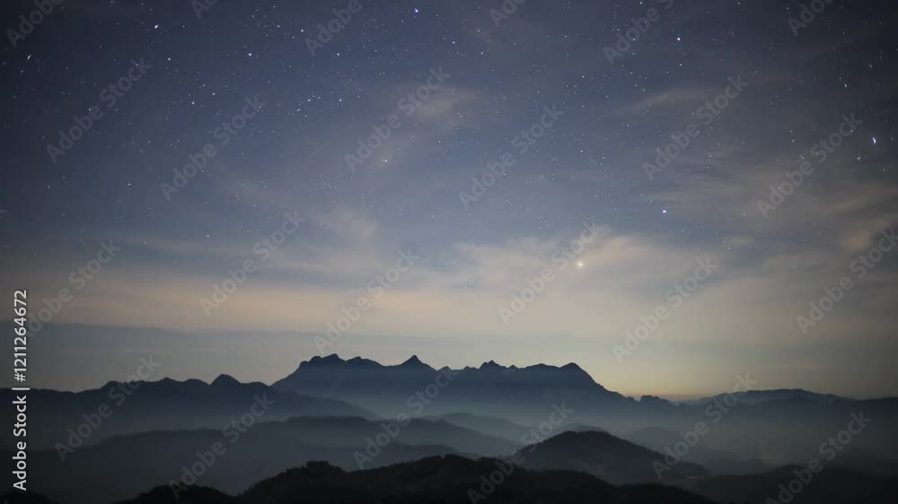 Night sky with moving stars above the northern landscape of Chiang Mai, Thailand with the famous Doi Luang Chiang Dao seen in the distant Night sky with moving stars above the northern landscape of Chiang Mai, Thailand with the famous Doi Luang Chiang Dao seen in the distant