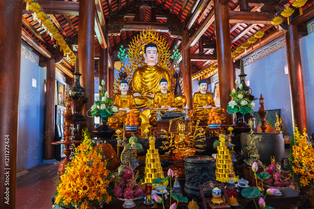 Fototapeta premium There are many Buddhist golden Buddha statues inside a temple in a pagoda in Nha Trang, Asia