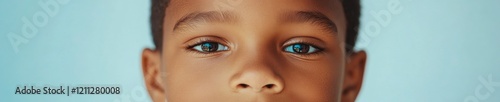 Vibrant Portrait Closeup of Black Childs Face with Blue Background - Humanitarian Content and Diversity in Social Advocacy Marketing photo