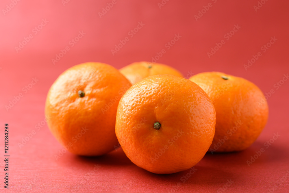 Mandarin tangerine orange fruit on red background, Lucky food in Lunar New Year or Chinese New Year Mandarin tangerine orange fruit on red background, Lucky food in Lunar New Year or Chinese New Year