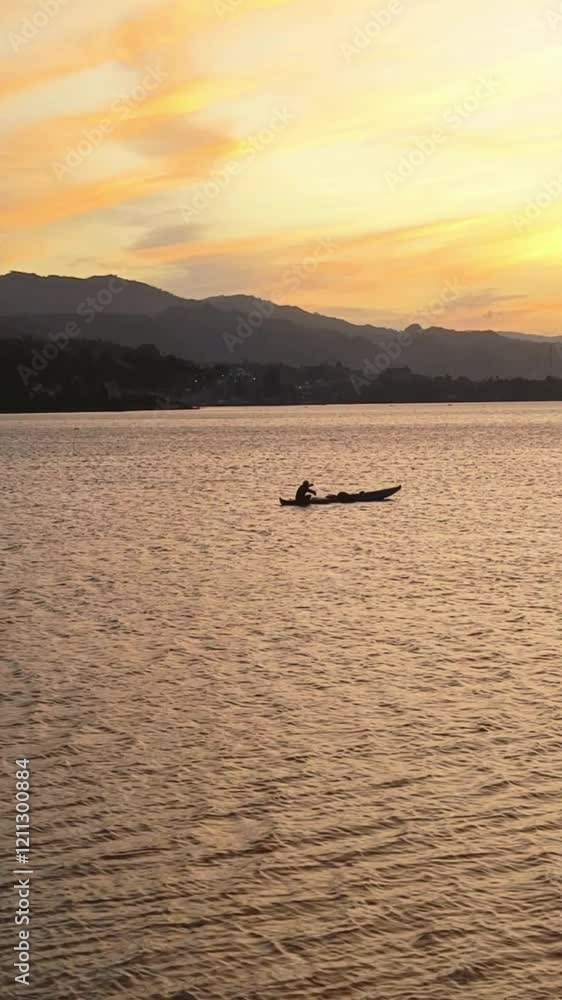 Silhouette of a fishing boat in the Limboto lake at sunset Silhouette of a fishing boat in the Limboto lake at sunset