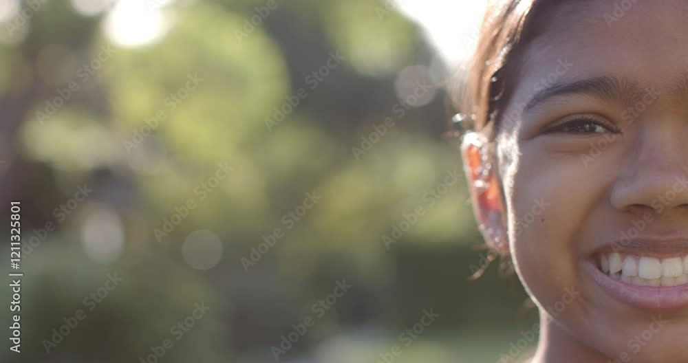 Smiling girl outdoors enjoying sunny day, close-up of face with blurred background, copy space Smiling girl outdoors enjoying sunny day, close-up of face with blurred background, copy space