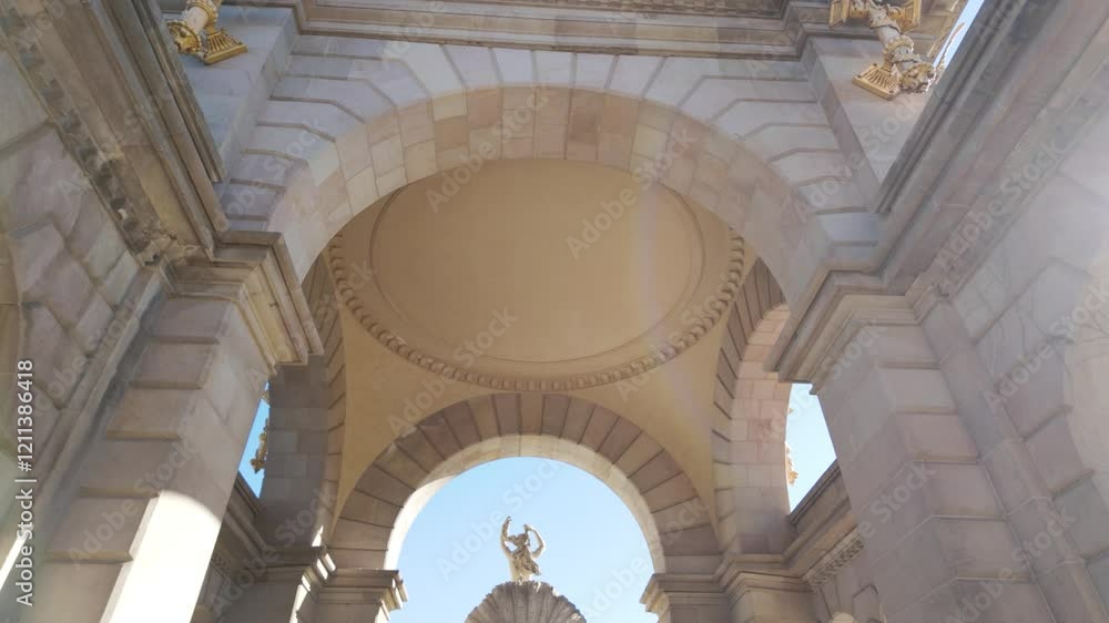 View of a detailed classical sculpture at Cascada Monumental, framed by a beautifully designed arch in Barcelona. The architectural elegance enhances the historic and cultural atmosphere. View of a detailed classical sculpture at Cascada Monumental, framed by a beautifully designed arch in Barcelona. The architectural elegance enhances the historic and cultural atmosphere.