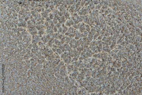Close-up texture on surface of damp sand on the beach