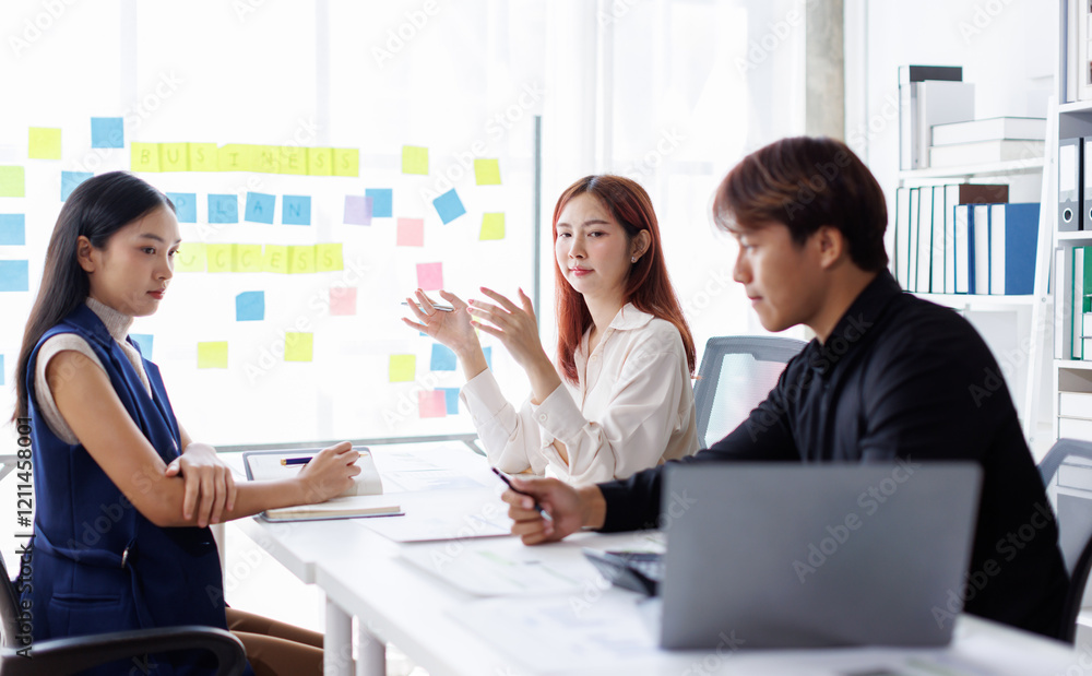 Diverse colleagues collaborative brainstorming at office briefing, Young Business Asian people explaining analysis at the meeting Multiethnic startup work. Diverse colleagues collaborative brainstorming at office briefing, Young Business Asian people explaining analysis at the meeting Multiethnic startup work.