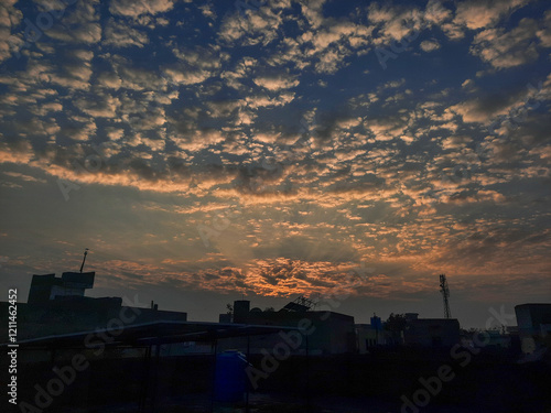 Sunset over the city and river with a silhouette of ships and buildings under a colorful sky photo