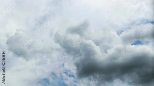 Bright white clouds fly across the bright blue sky. The sky is clear in the afternoon. Background view of clouds moving in the wind. Copy space