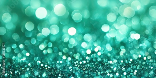 Shimmering turquoise glitter background with varying bokeh circles in soft focus positioned in the lower third of the image. photo