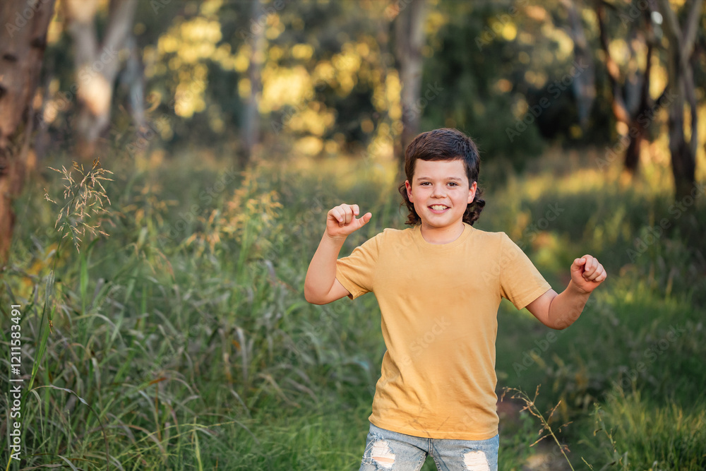 Portrait of happy boy wearing yellow shirt in Australian country bush setting Portrait of happy boy wearing yellow shirt in Australian country bush setting