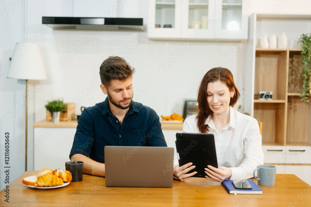 Modern couple collaborating over coffee in a cozy kitchen setting with a laptop, notebook, and breakfast. Modern couple collaborating over coffee in a cozy kitchen setting with a laptop, notebook, and breakfast.