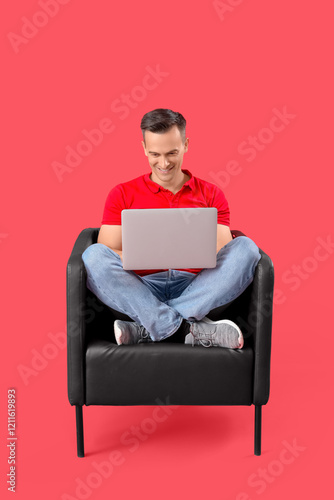 Handsome man using laptop i...