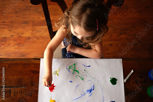 From above toddler painting on white paper photo