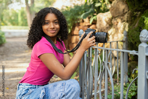 Young photographer taking pictures in a park photo