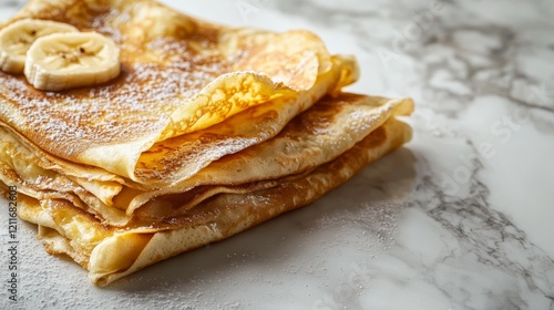 Displaying Stacked Crepes with Banana and Powdered Sugar